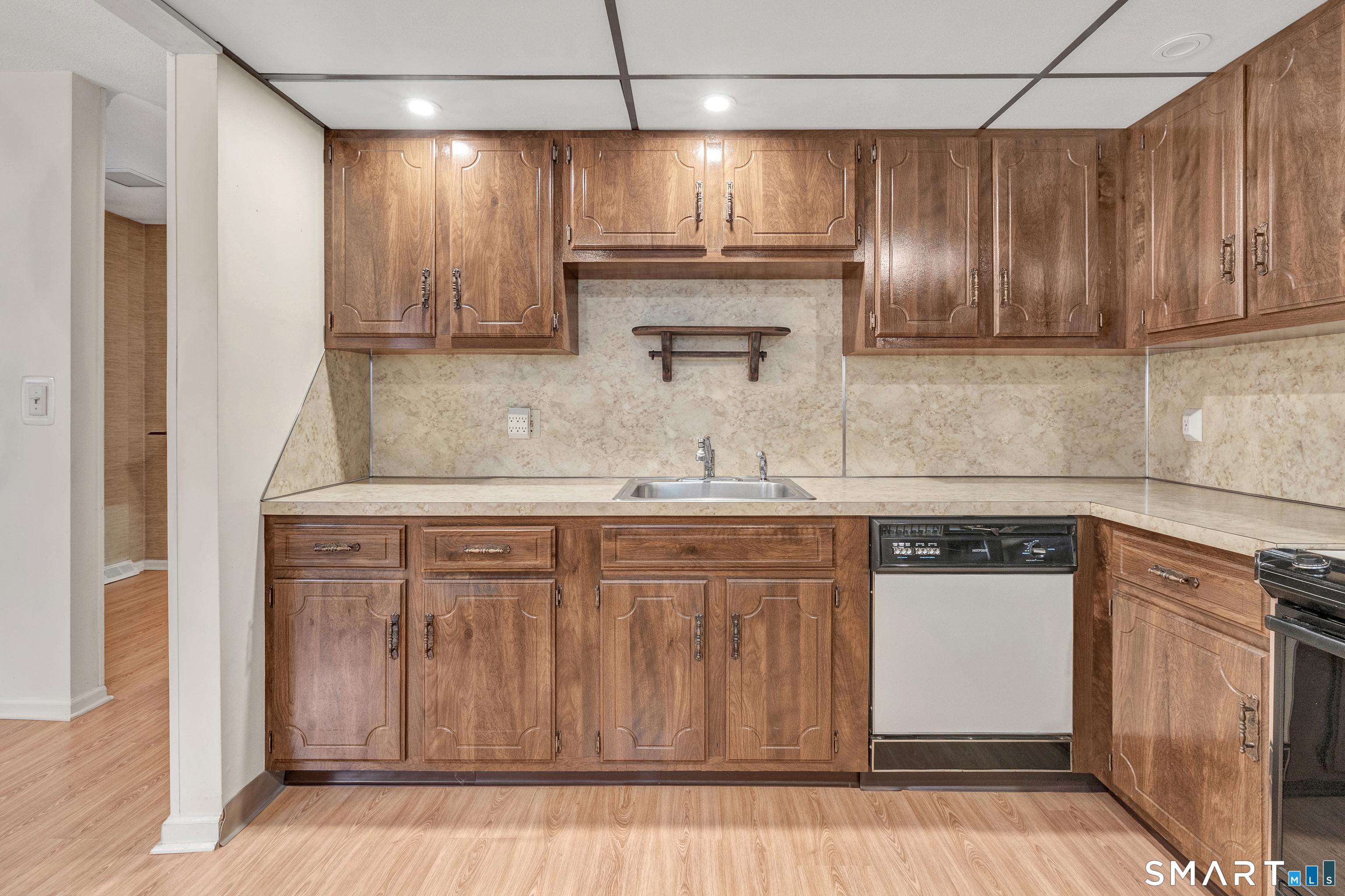 330 Merwin Avenue, Unit 1D Milford, CT 06460 - Photo 11 of 39 a kitchen with kitchen island granite countertop stainless steel appliances a sink stove refrigerator and cabinets
