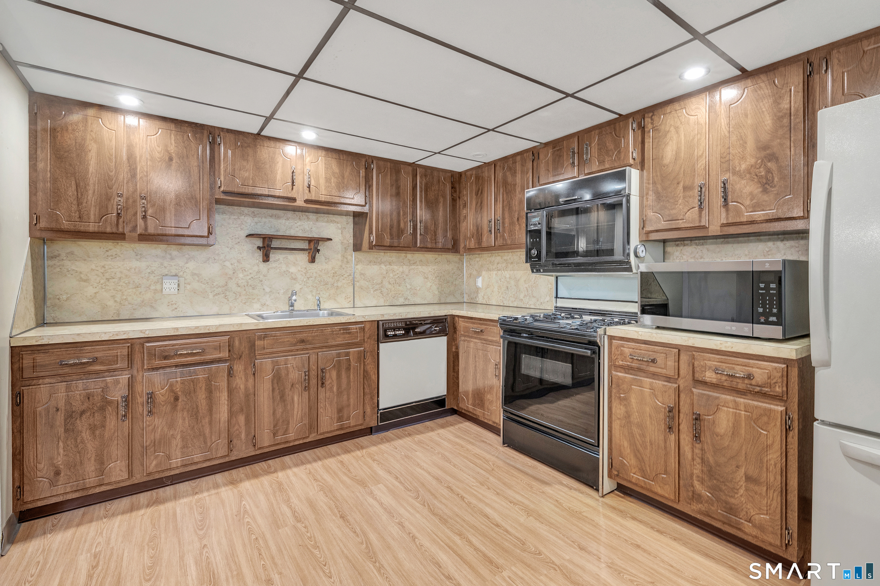 330 Merwin Avenue, Unit 1D Milford, CT 06460 - Photo 12 of 39 a kitchen with stainless steel appliances granite countertop a stove sink and microwave