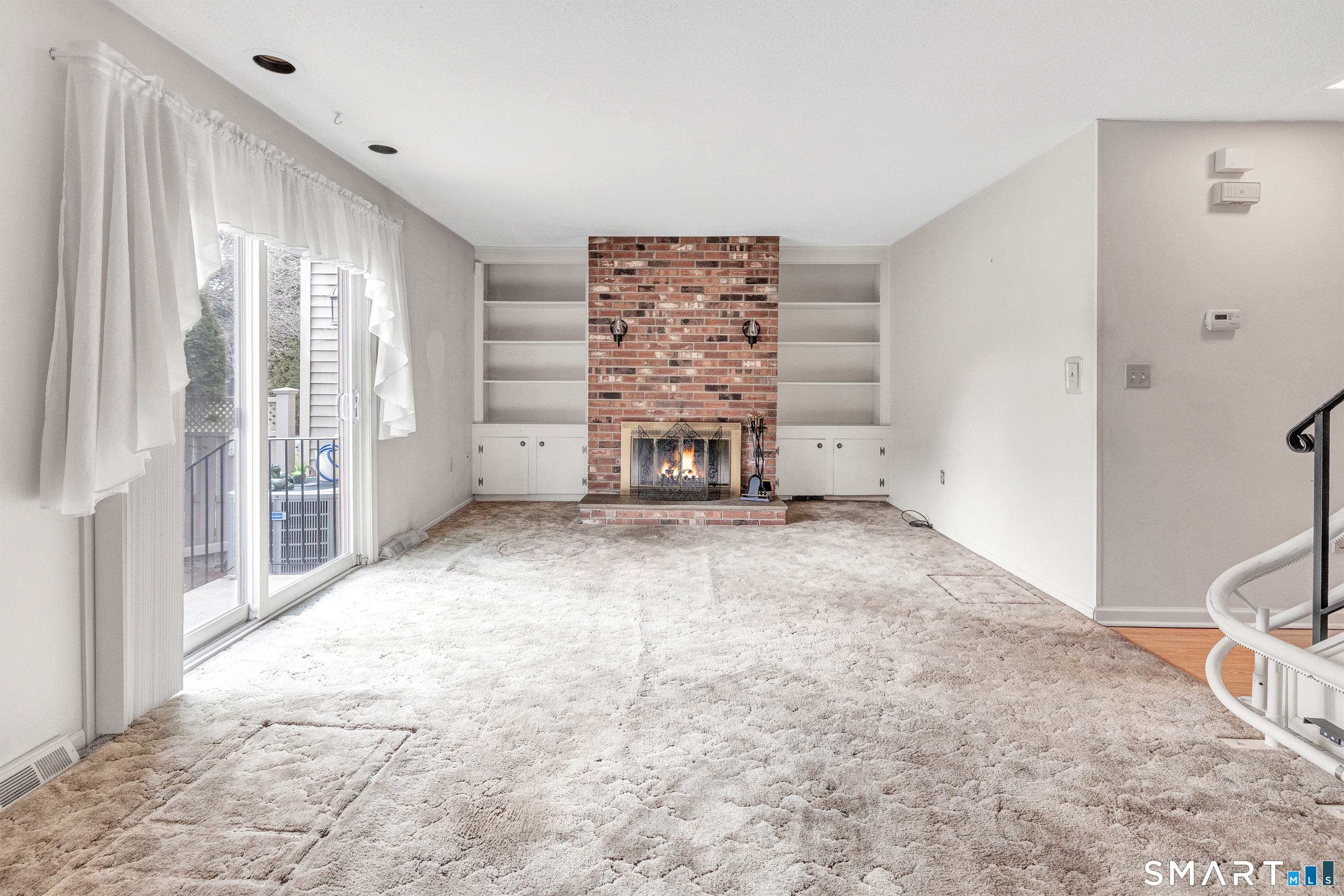 330 Merwin Avenue, Unit 1D Milford, CT 06460 - Photo 15 of 39 a view of an empty room with a fireplace and a window