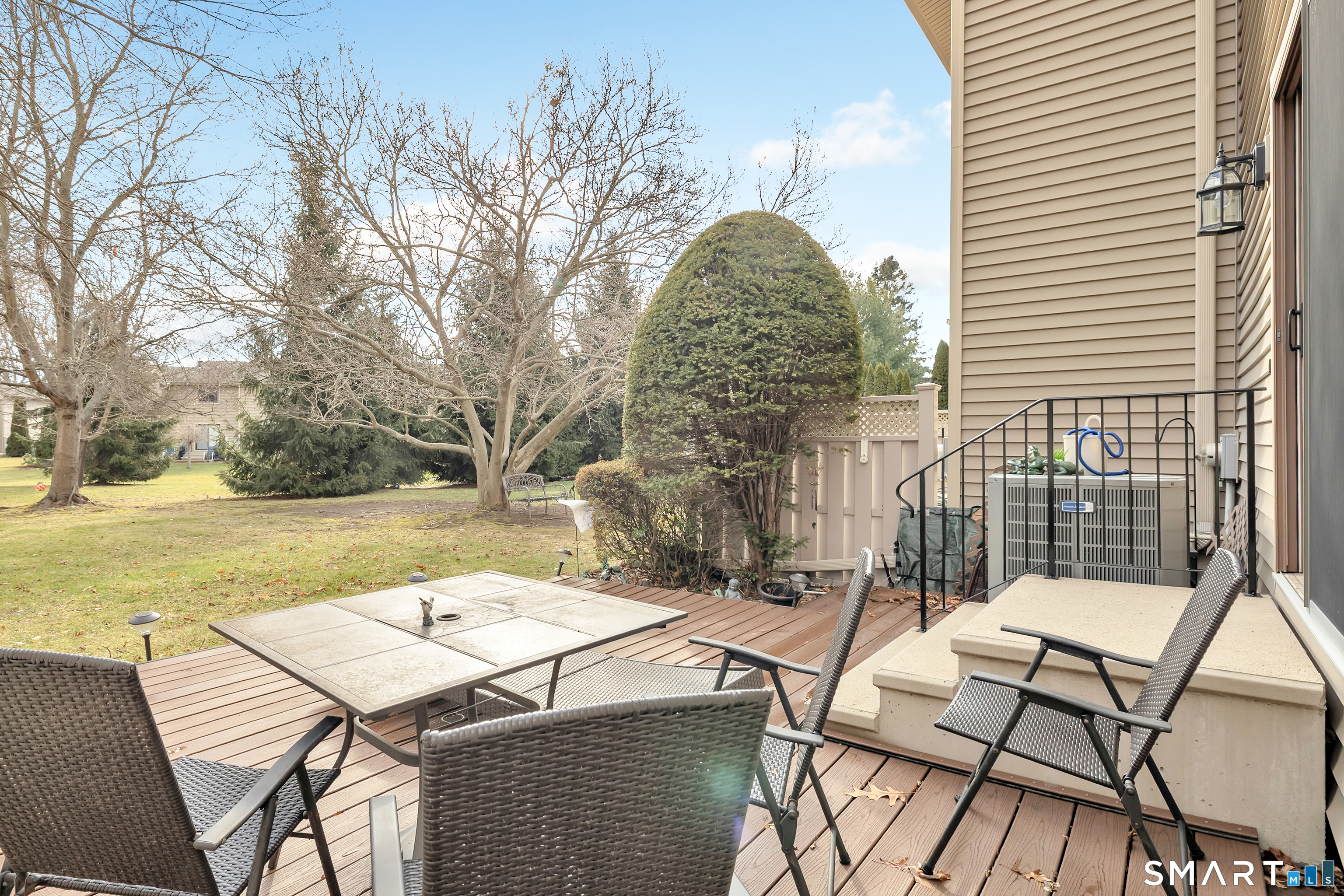 330 Merwin Avenue, Unit 1D Milford, CT 06460 - Photo 31 of 39 a view of a patio with table and chairs with wooden floor and fence