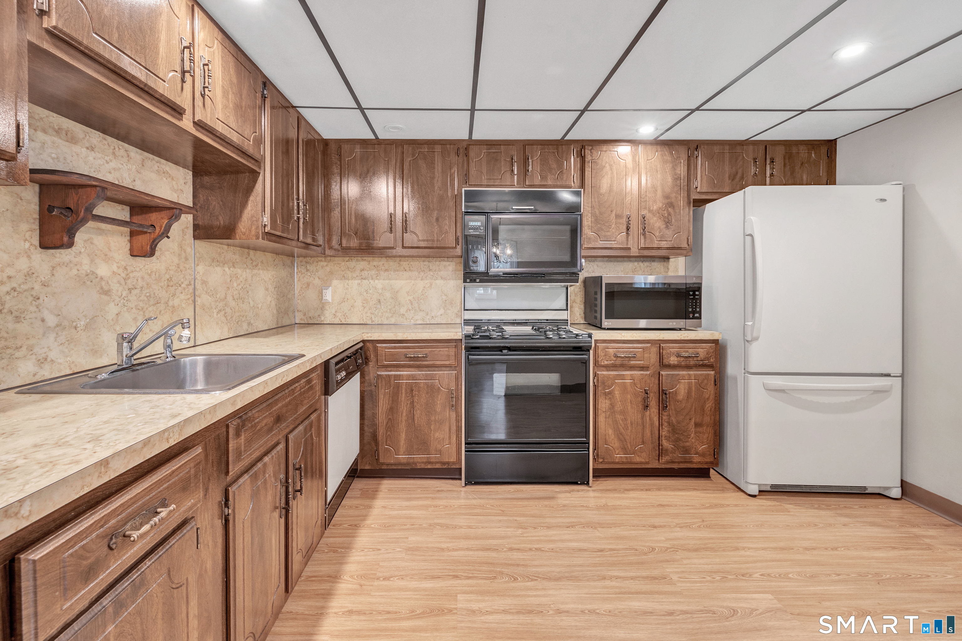 330 Merwin Avenue, Unit 1D Milford, CT 06460 - Photo 10 of 39 a kitchen with a refrigerator and a sink