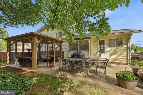 a view of a house with backyard porch and sitting area
