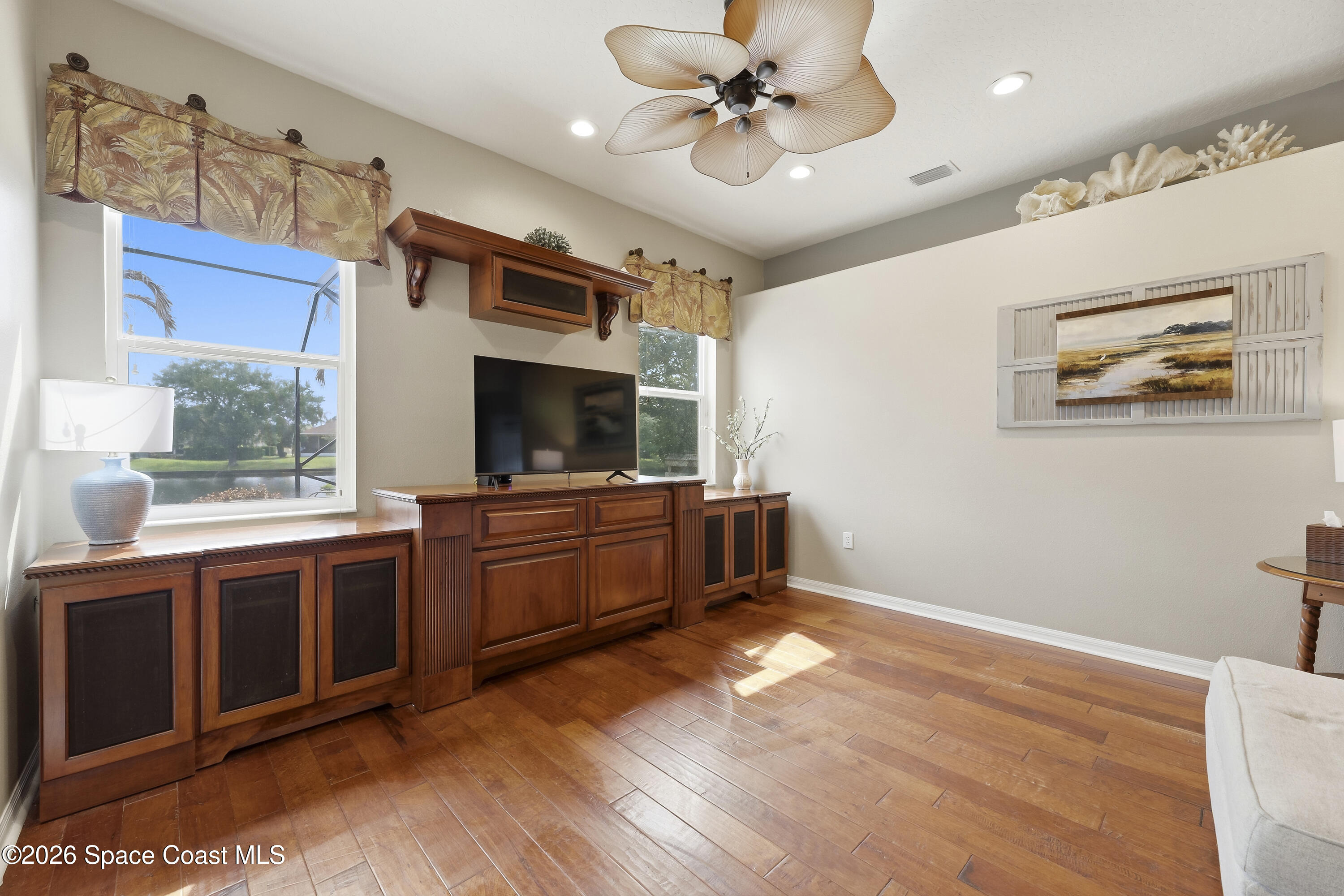 1643 Long Pine Road Melbourne, FL 32940 - Photo 14 of 63 a view of a room with cabinet flat screen tv and windows
