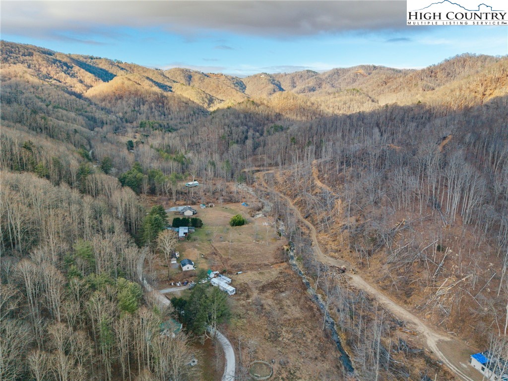 295 Jake's Mountain Road Boone, NC 28607 - Photo 42 of 47 a view of a dry yard with mountains in the background
