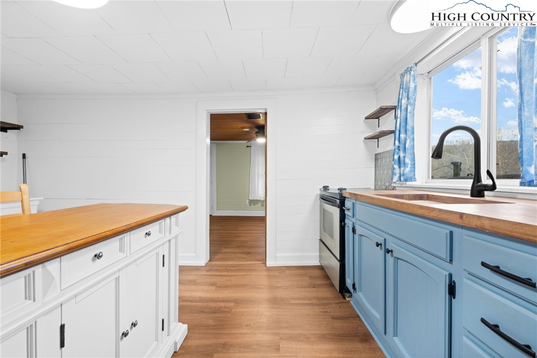 295 Jake's Mountain Road Boone, NC 28607 - Photo 6 of 47 a kitchen with a sink and a refrigerator