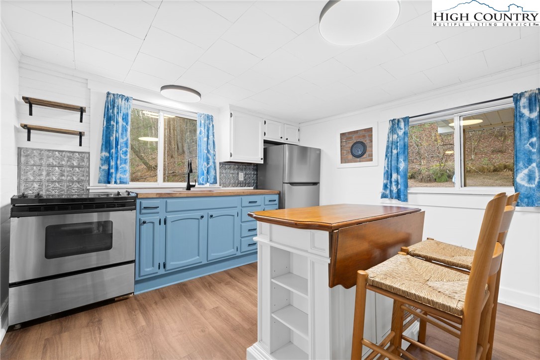 295 Jake's Mountain Road Boone, NC 28607 - Photo 9 of 47 a kitchen with stainless steel appliances granite countertop a stove a sink and a refrigerator