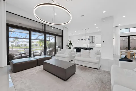 a kitchen with stainless steel appliances kitchen island granite countertop a stove a sink a oven a dining table and chairs