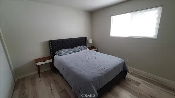 a living room with a bed furniture and a large window