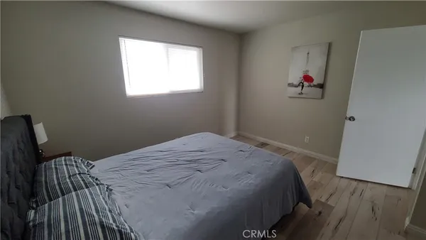 a living room with a bed furniture and a large window