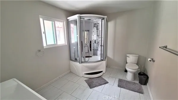 a large bed sitting in a bedroom next to a window