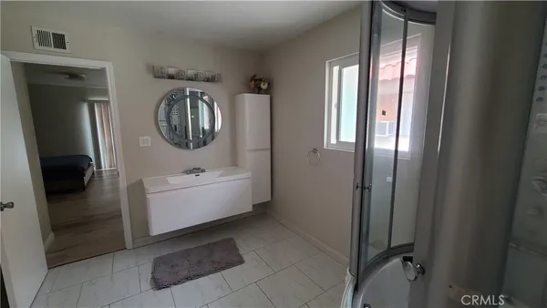 a bedroom with a bed and window