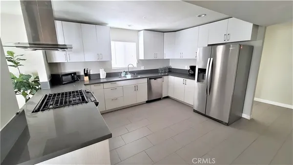 a kitchen with a sink cabinets and window