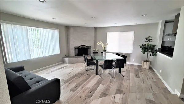 a dining room with furniture and wooden floor