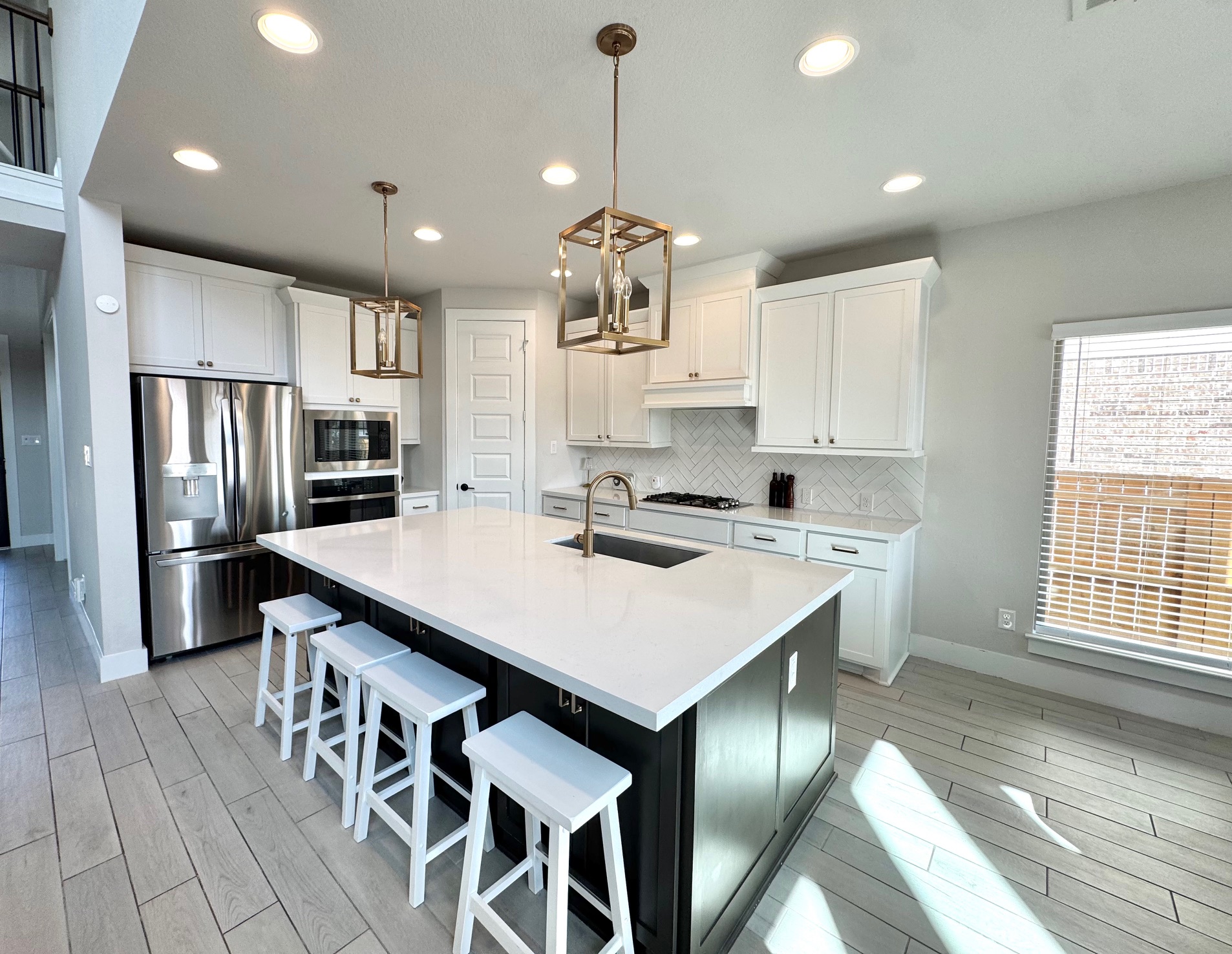 561 Cold Riv Run Kyle, TX 78640 - Photo 5 of 33 a kitchen with stainless steel appliances a table chairs sink refrigerator and cabinets