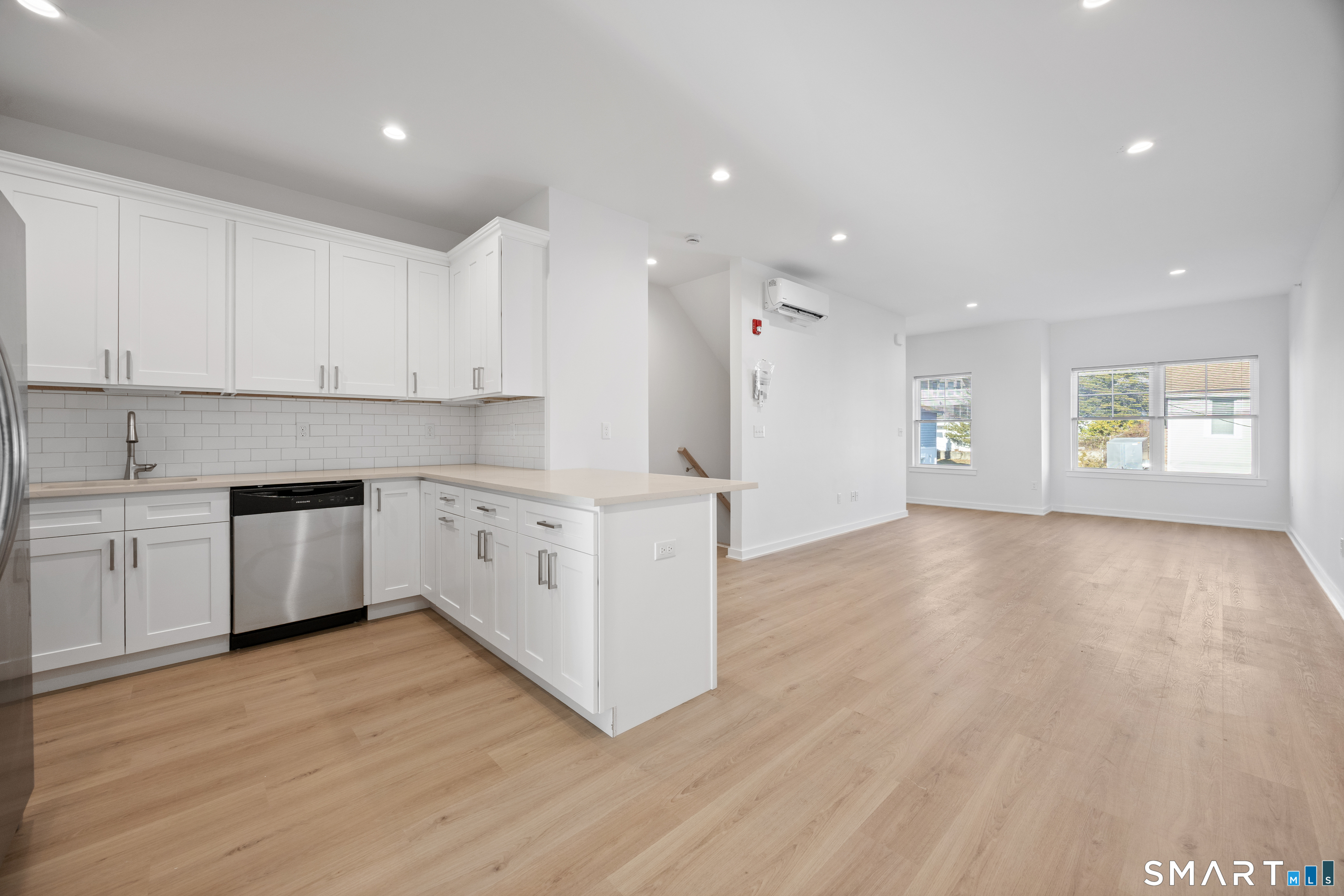 27 Village Road, Unit F Milford, CT 06460 - Photo 7 of 15 a large kitchen with stainless steel appliances granite countertop a stove a sink and white cabinets