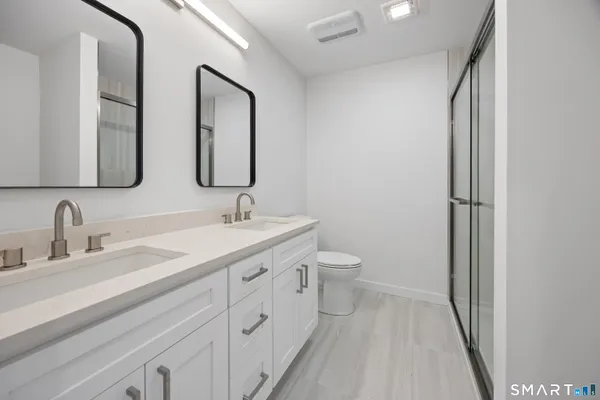 a spacious bathroom with a double vanity sink and a mirror