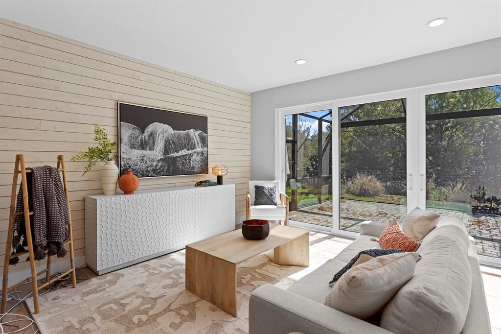 8057 Tidal Pointe Way Sarasota, FL 34240 - Photo 11 of 27 a living room with furniture and a floor to ceiling window