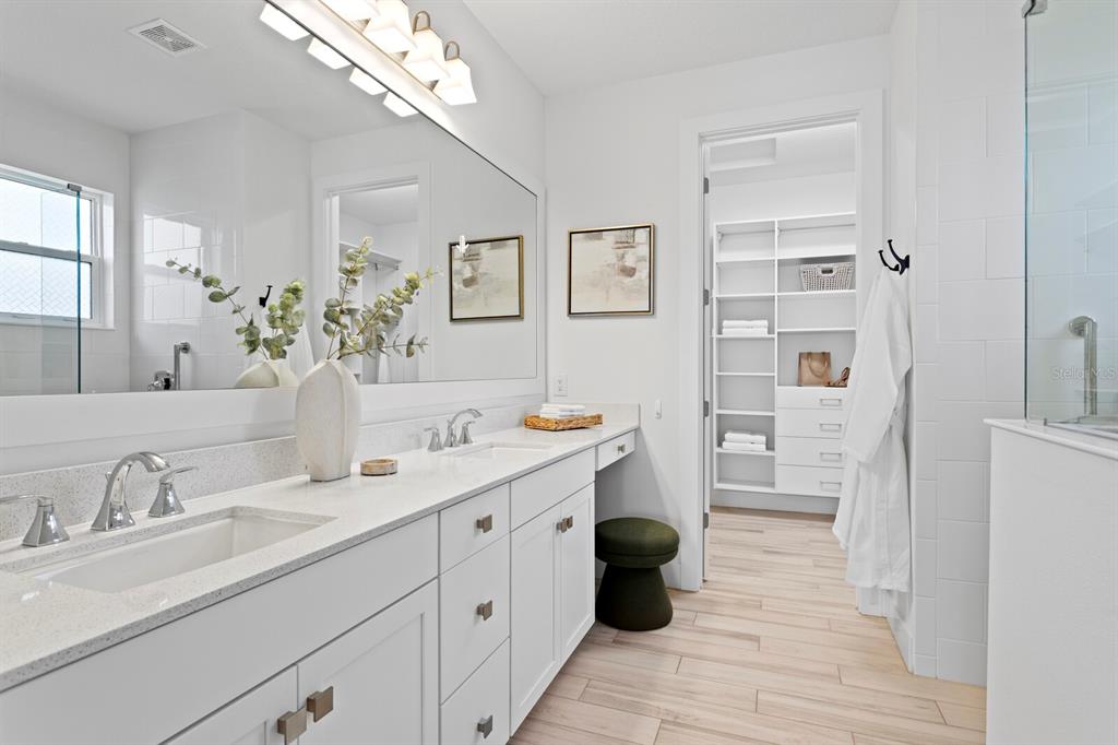 8057 Tidal Pointe Way Sarasota, FL 34240 - Photo 16 of 27 a spacious bathroom with a granite countertop sink mirror and bathtub