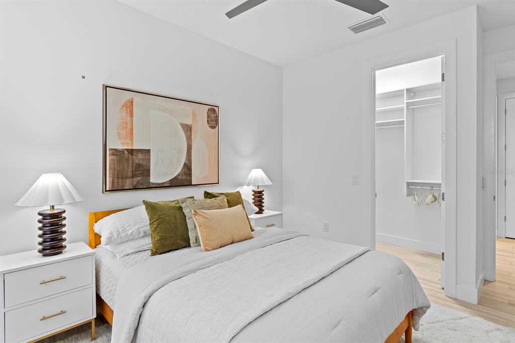 8057 Tidal Pointe Way Sarasota, FL 34240 - Photo 19 of 27 a bedroom with a bed and a mirror