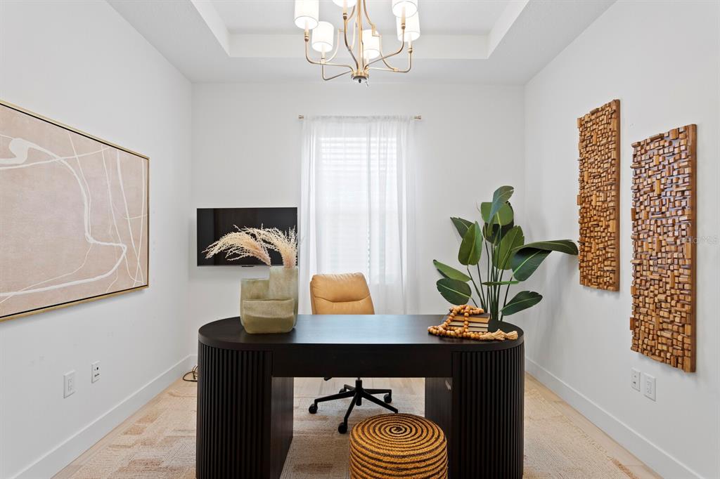 8057 Tidal Pointe Way Sarasota, FL 34240 - Photo 21 of 27 a living room with furniture and a potted plant