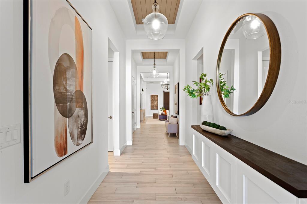 8057 Tidal Pointe Way Sarasota, FL 34240 - Photo 3 of 27 an entryway with sitting space and wooden floor