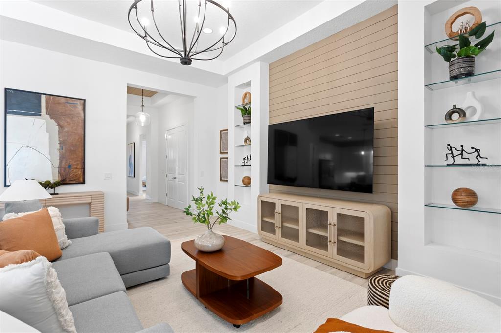 8057 Tidal Pointe Way Sarasota, FL 34240 - Photo 6 of 27 a living room with furniture a flat screen tv and a fireplace