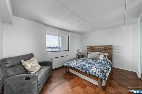 a bedroom with a bed and a couch