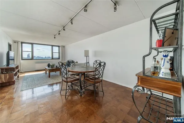 a view of a dining room with furniture and wooden floor