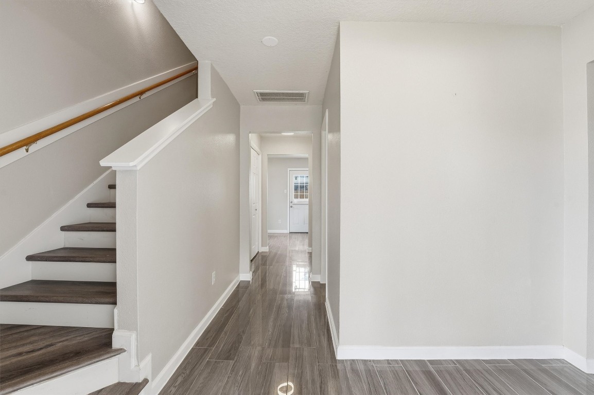 15403 Apple Bloom Way Channelview, TX 77530 - Photo 11 of 25 a view of a hallway with wooden floor and entryway