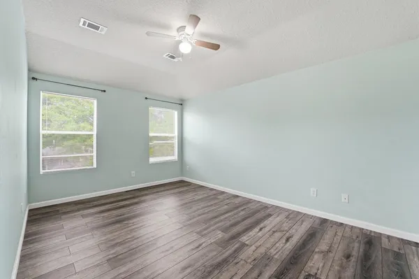 wooden floor in an empty room with a window