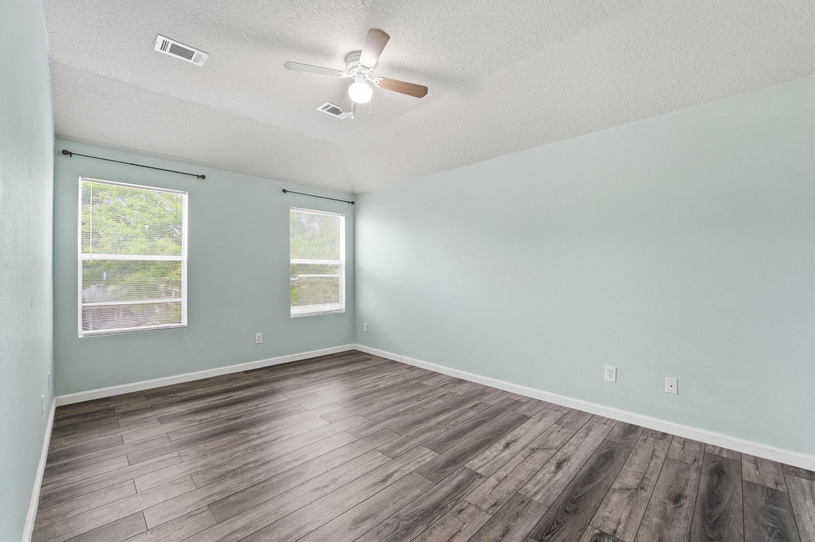 15403 Apple Bloom Way Channelview, TX 77530 - Photo 18 of 25 wooden floor in an empty room with a window