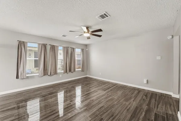 wooden floor in an empty room with a window