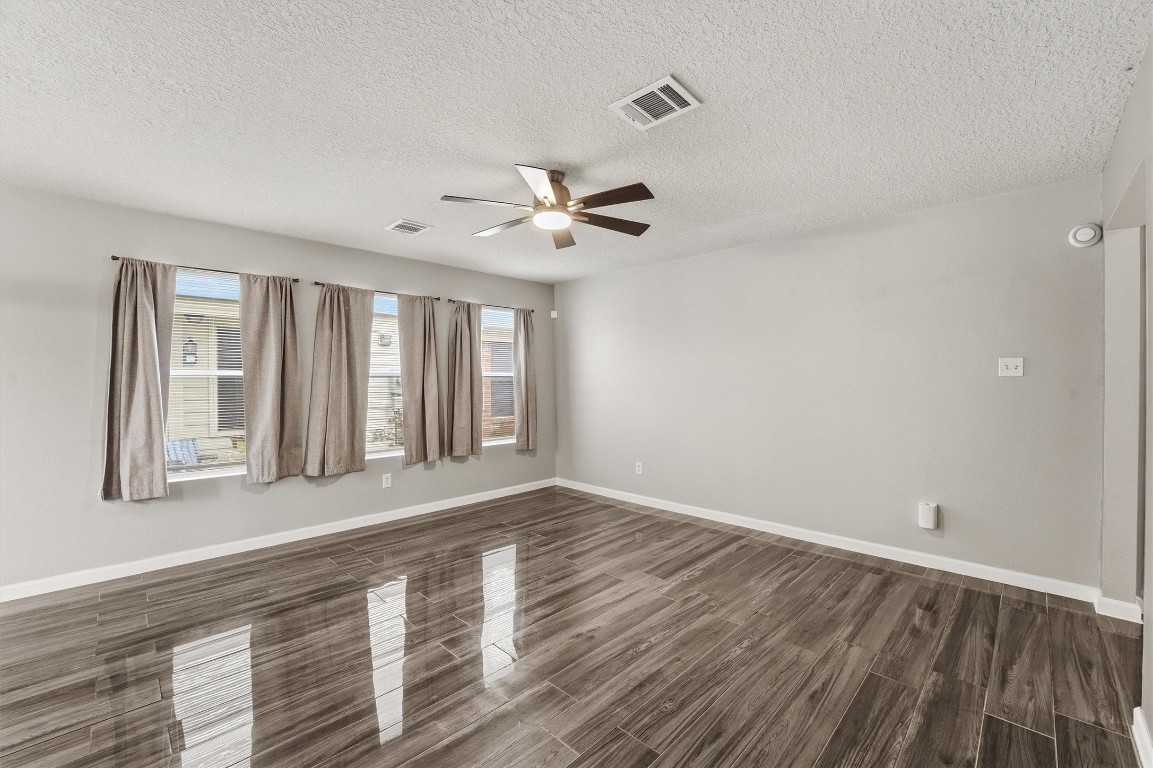 15403 Apple Bloom Way Channelview, TX 77530 - Photo 5 of 25 wooden floor in an empty room with a window