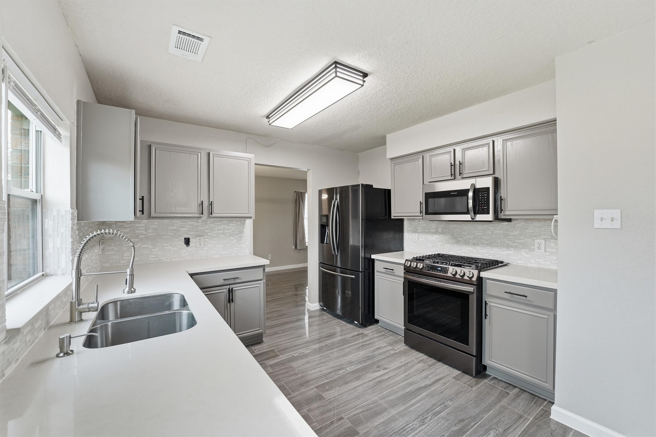 15403 Apple Bloom Way Channelview, TX 77530 - Photo 8 of 25 a kitchen with stainless steel appliances granite countertop a sink stove and refrigerator