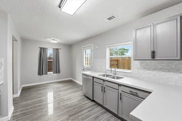 a kitchen with stainless steel appliances granite countertop a sink stove and cabinets