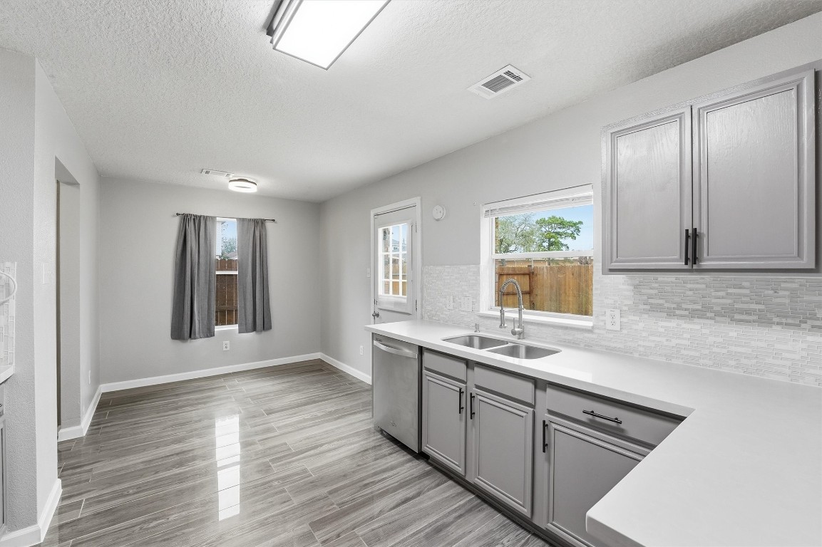 15403 Apple Bloom Way Channelview, TX 77530 - Photo 9 of 25 a kitchen with stainless steel appliances granite countertop a sink stove and cabinets