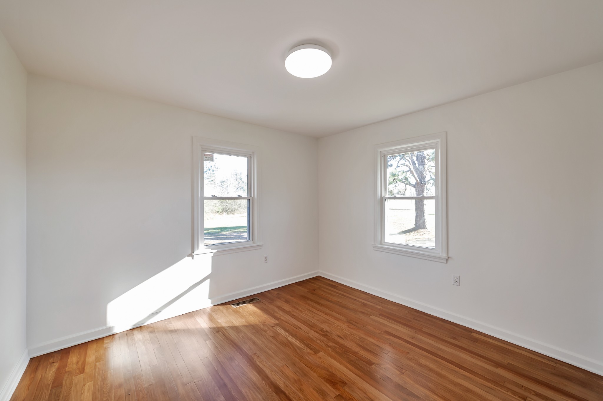 5774 Bending Chestnut Road Franklin, TN 37064 - Photo 11 of 17 an empty room with wooden floor and windows