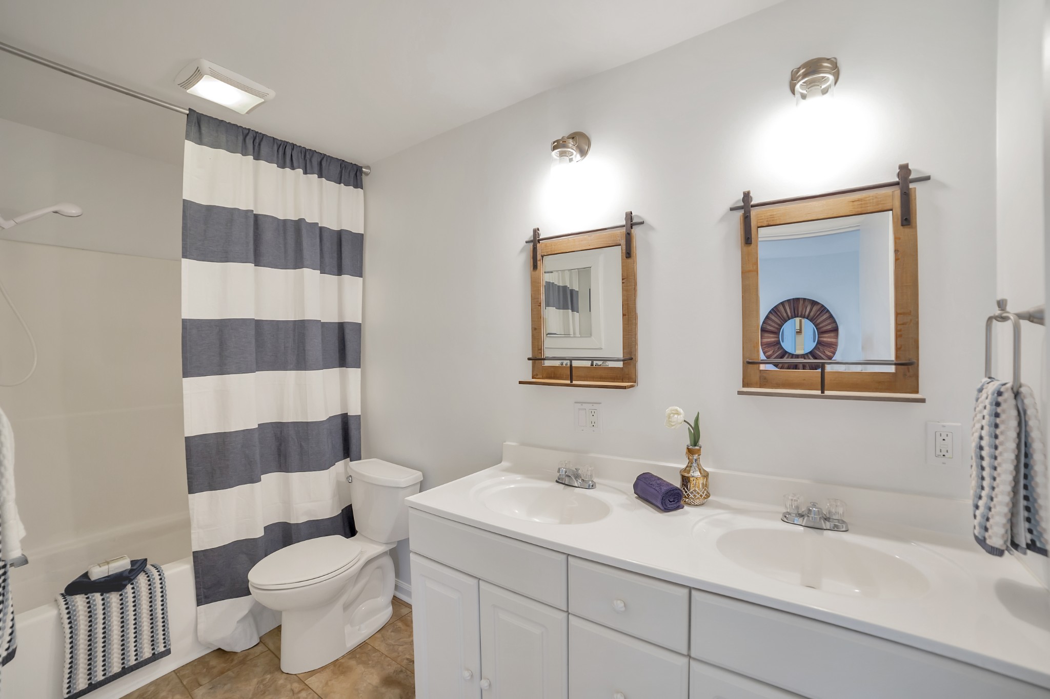 5774 Bending Chestnut Road Franklin, TN 37064 - Photo 10 of 17 a bathroom with a sink a toilet a shower and a mirror