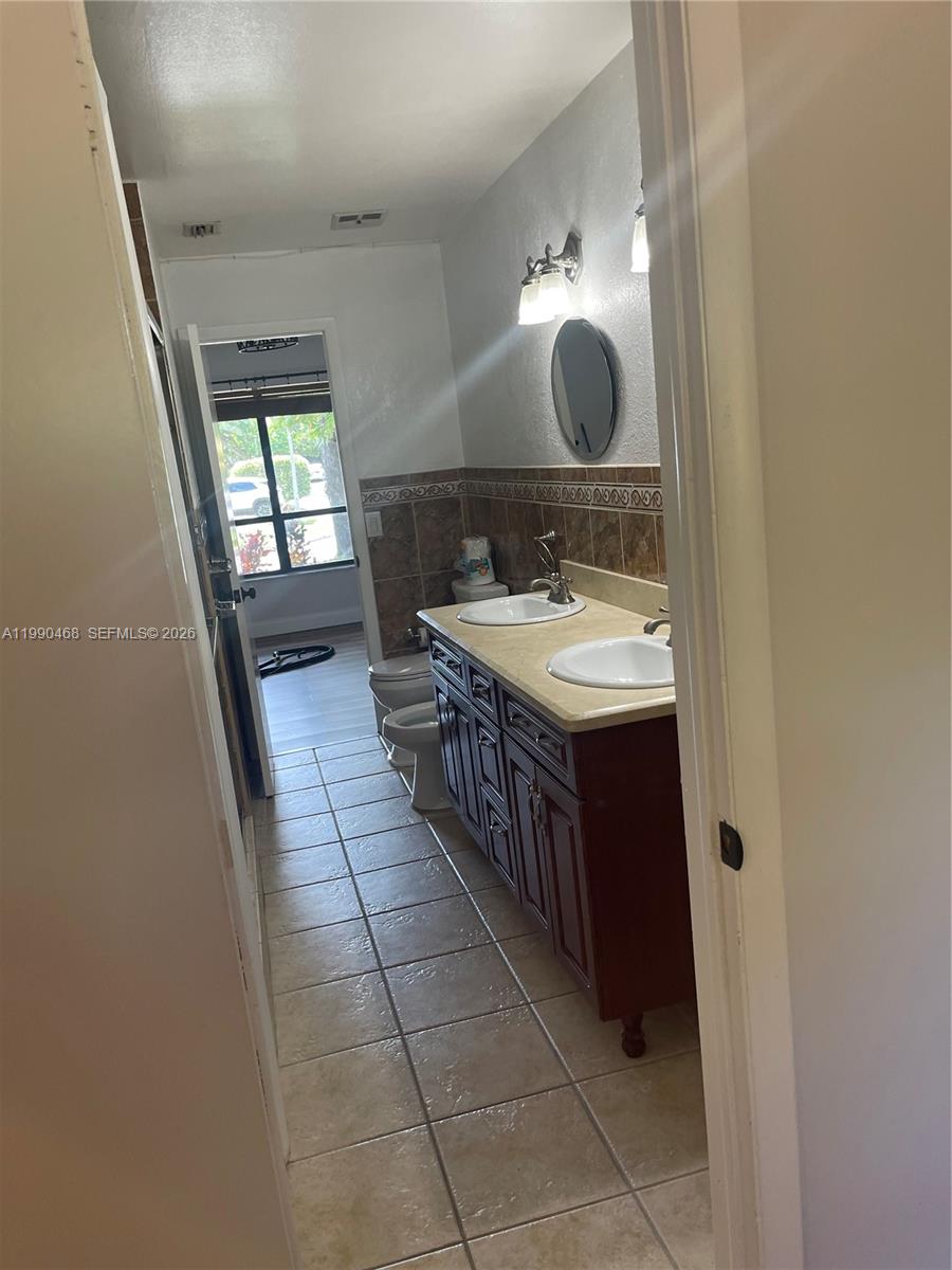 11269 Southwest 116th Terrace, Unit 11269 Miami, FL 33176 - Photo 8 of 11 a bathroom with a sink a vanity and a mirror