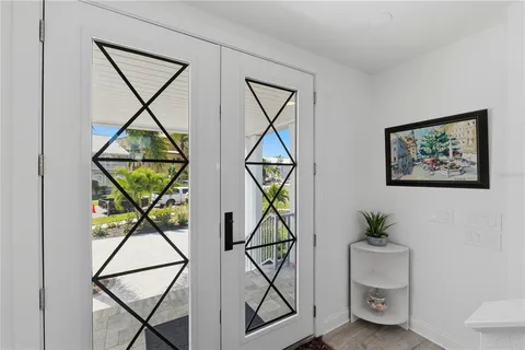 a living room with furniture a flat screen tv and a large window