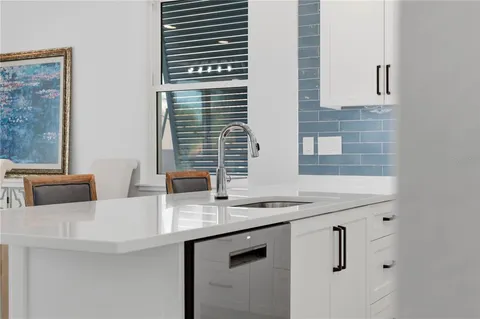 a view of a patio with a table and chairs under an umbrella