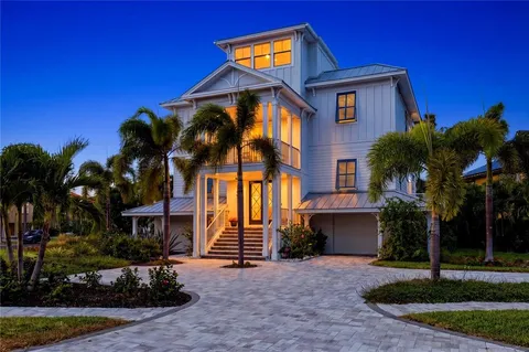 a living room with furniture kitchen view and a potted plant