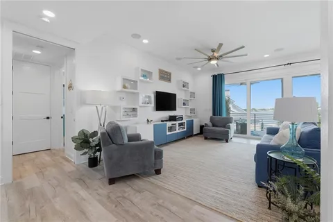 a view of a room with wooden floor and a potted plant