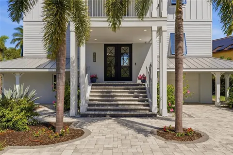 a living room with furniture and a view of kitchen