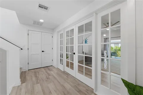 a view of a house with a yard and a pond