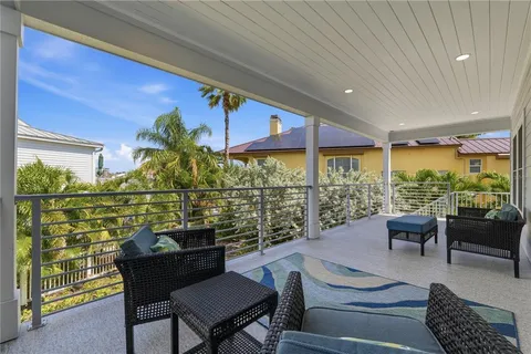 a view of a balcony with table and chairs