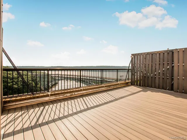 a view of wooden balcony with a floor to ceiling window