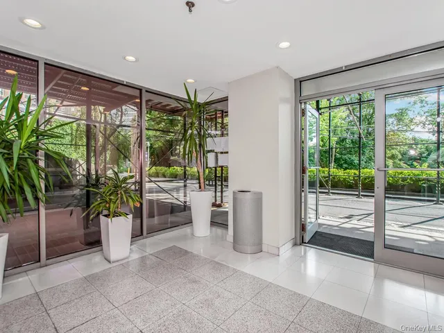 a lobby with furniture and floor to ceiling window