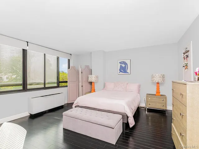 a spacious bedroom with a bed and a large window