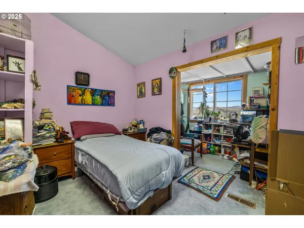 a bedroom with a bed a table and chair